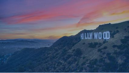 An image of the HOLLYWOOD sign of Los Angeles, located in mountainous terrain with a colorful sunset in the background and a dark overlay on the image.