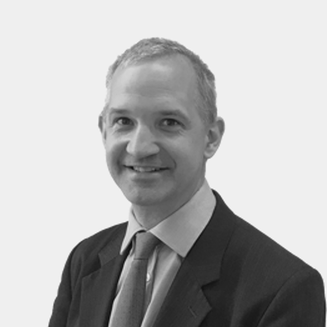 An image of a man named Chris Egerton-Warburton. It is a black and white image and he appears to have white skin, gray-ish hair, and is wearing a suit and tie.